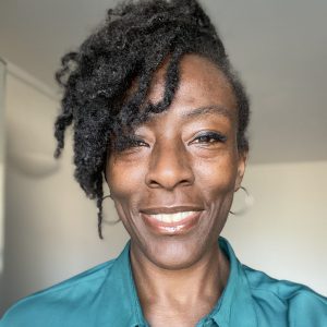 Woman smiling, promoting mental well-being and mindfulness.