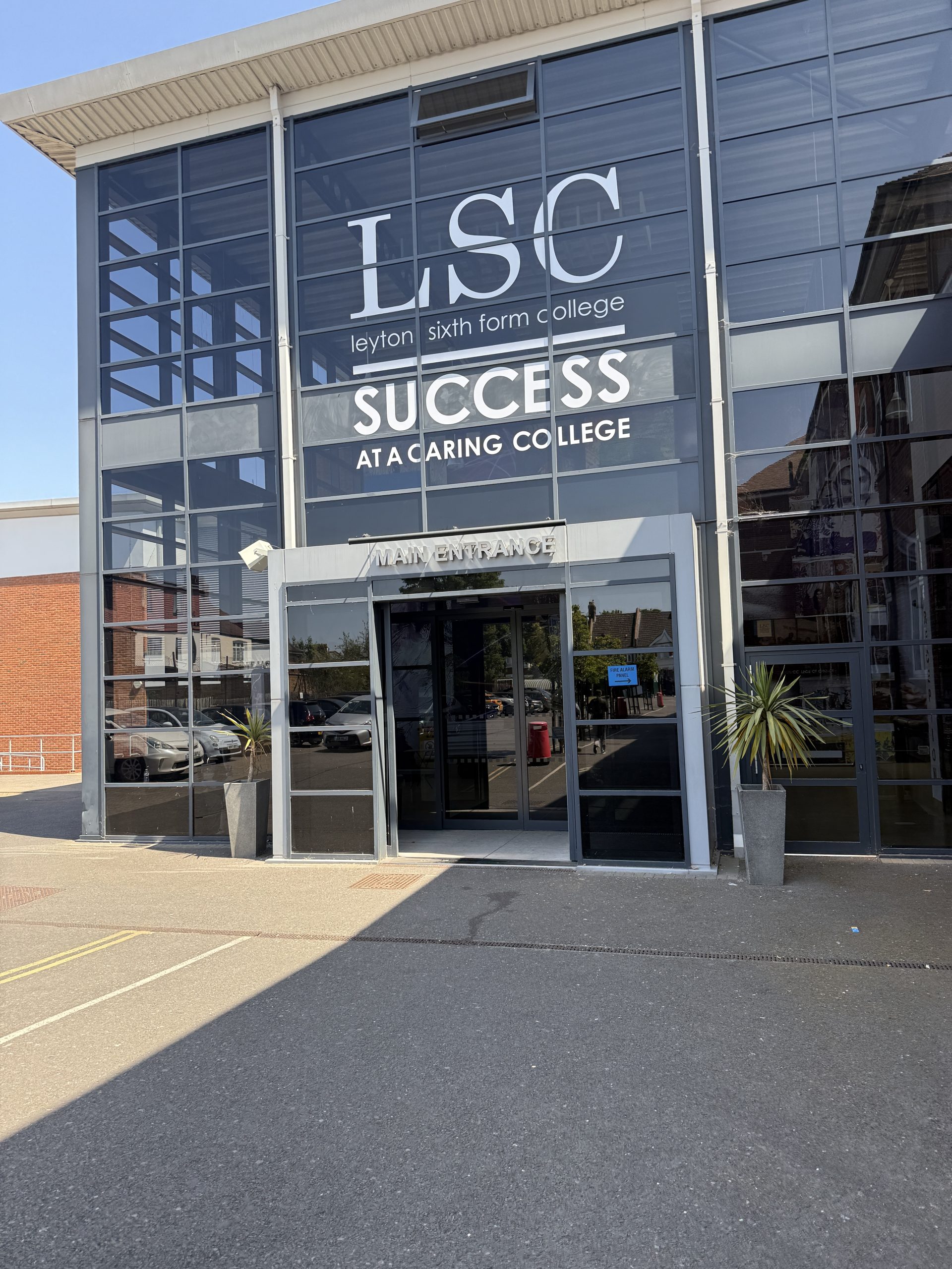 A glass fronted building in the sunlight. A 6th form college, Leyton Sixth Form College in London.